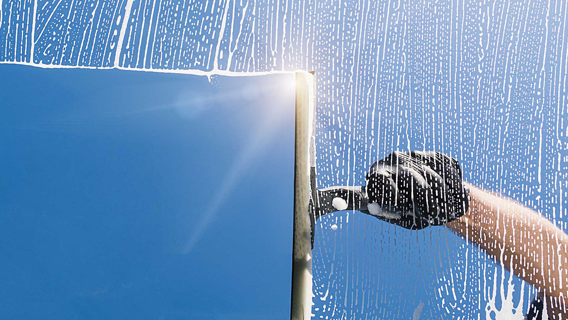 man cleaning window of elite carpal tunnel